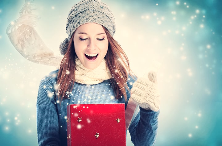 graphicstock happy young woman opening a christmas present